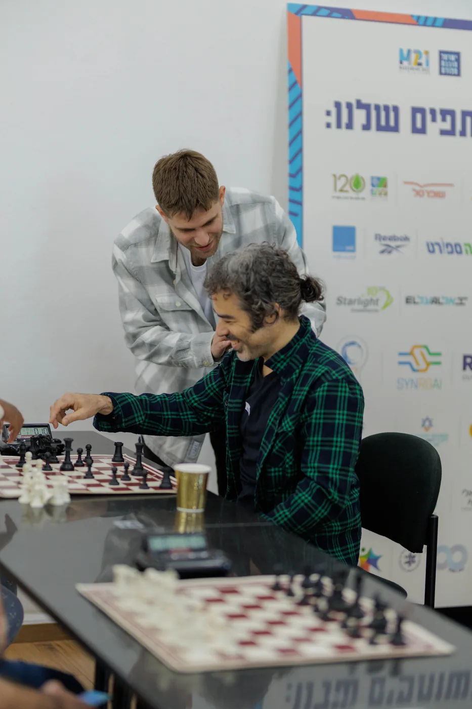 ניצן שטיינברג עם משתתף מול השעון באירוע הקהילה